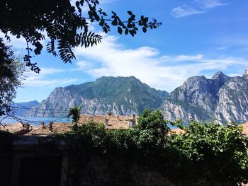 Houses by mountains against sky