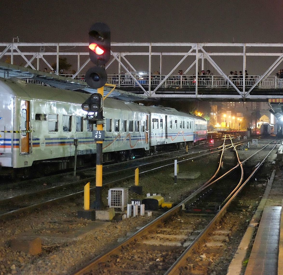 transportation, railroad track, public transportation, rail transportation, railroad station platform, railroad station, mode of transport, travel, illuminated, arriving, railway signal, outdoors, arrival, city life, railroad tracks