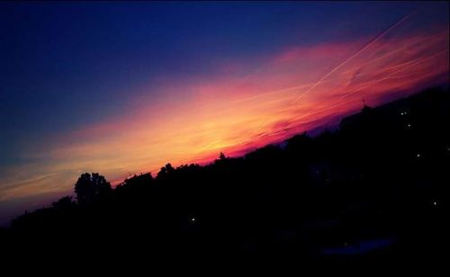 Scenic view of silhouette landscape against sky at sunset