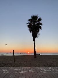 Scenic view of sea against clear sky at sunset