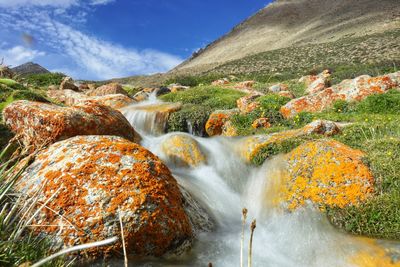 Scenic view of waterfall against sky