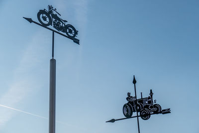 Low angle view of weather vane against clear sky