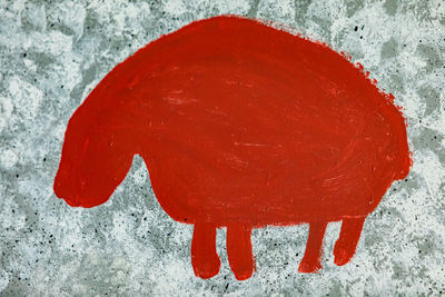 High angle view of snow on red wall