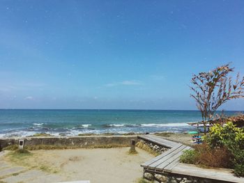 Scenic view of sea against clear blue sky