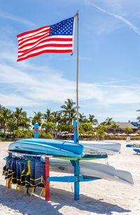 Flags on table against blue sky