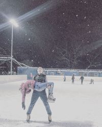 People walking on snow covered field during winter