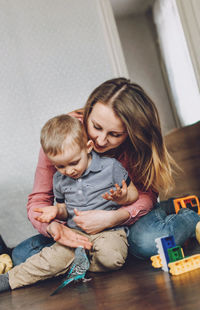 Mother playing with son at home