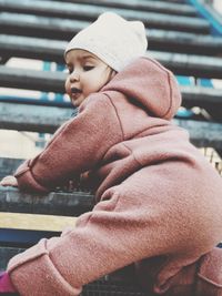 Side view of baby girl wearing hat