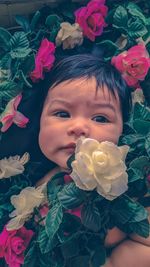 Close-up portrait of cute girl with pink flowers