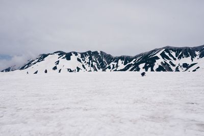 Scenic view of snow covered mountains against sky