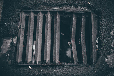 High angle view of old metal grate on wall