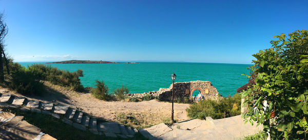 Panoramic shot of sea against clear blue sky