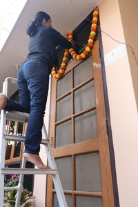 Low angle view of man on staircase against building