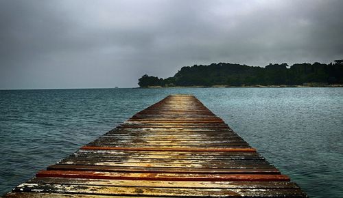 Pier over sea against sky