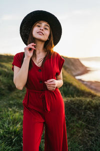 Full length of woman standing on field against sky