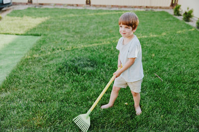 Full length of boy standing on grassy field