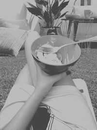 High angle view of woman holding food on table