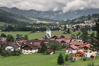 High angle view of houses against cloudy sky