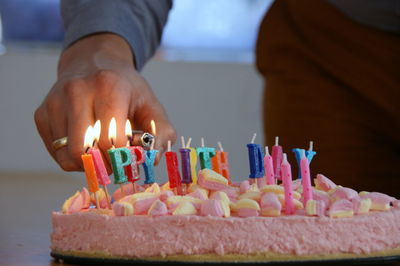 Close-up of hand holding cake