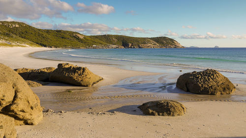 Rocks on beach against sky