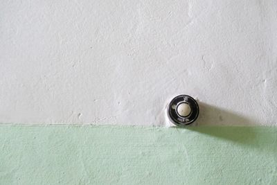 Close-up of doorbell on wall