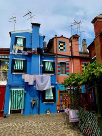 Clothes drying against buildings in city