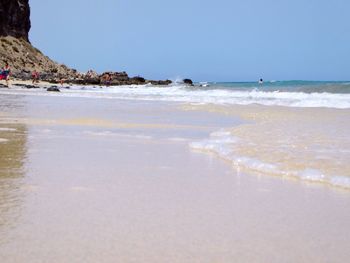 Scenic view of beach against clear sky