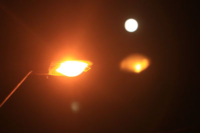 Close-up of illuminated orange sun