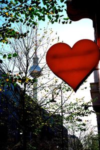 Low angle view of heart shape on tree against sky