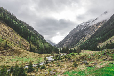 Scenic view of mountains against cloudy sky