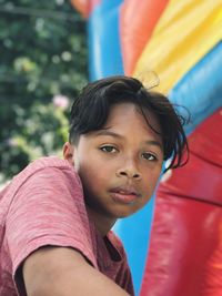 Close-up portrait of boy playing on bouncy castle