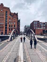 People walking on footpath in city