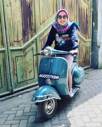 Portrait of young woman sitting outdoors