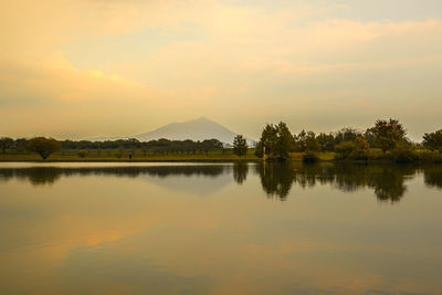 Scenic view of lake against sky during sunset