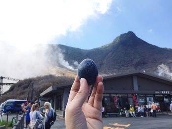 People on mountain against sky