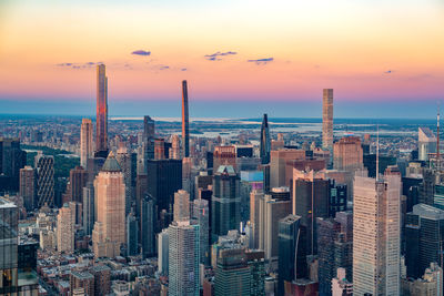 Aerial view of cityscape against sky during sunset