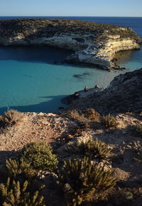 High angle view of rocks by sea against sky