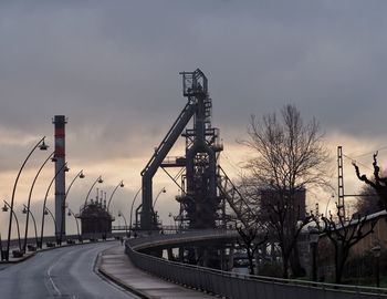 View of factory against cloudy sky