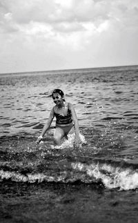 Full length of woman in sea against sky