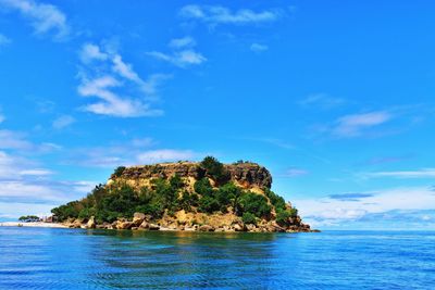 Cliff amidst sea against sky