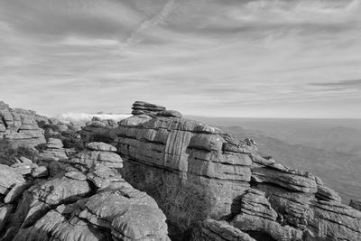 Rock formations on landscape against sky