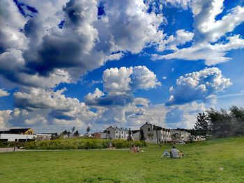 Houses on field against sky