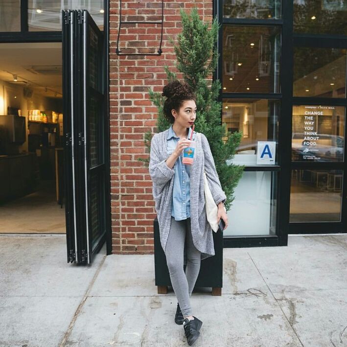 full length, young adult, casual clothing, lifestyles, building exterior, person, front view, young women, architecture, built structure, looking at camera, leisure activity, standing, portrait, three quarter length, city, jacket