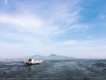 Boats in sea against sky