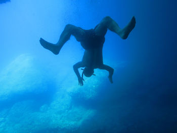 Full length of man swimming undersea 