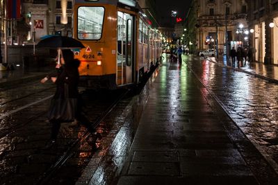 View of illuminated city street at night