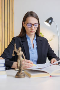 Portrait of young businesswoman working at desk in office