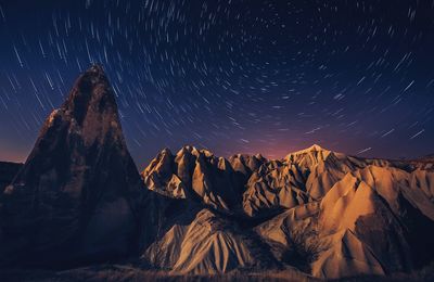 Panoramic view of mountains against sky at night