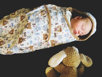 Close-up of cute bay boy sleeping on bed at home