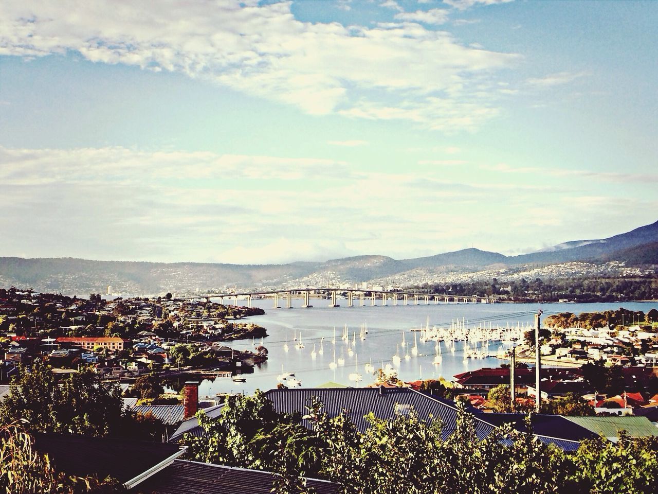 mountain, sky, architecture, built structure, building exterior, mountain range, cloud - sky, cityscape, water, city, high angle view, sea, crowded, nature, residential district, cloud, scenics, town, residential building, residential structure